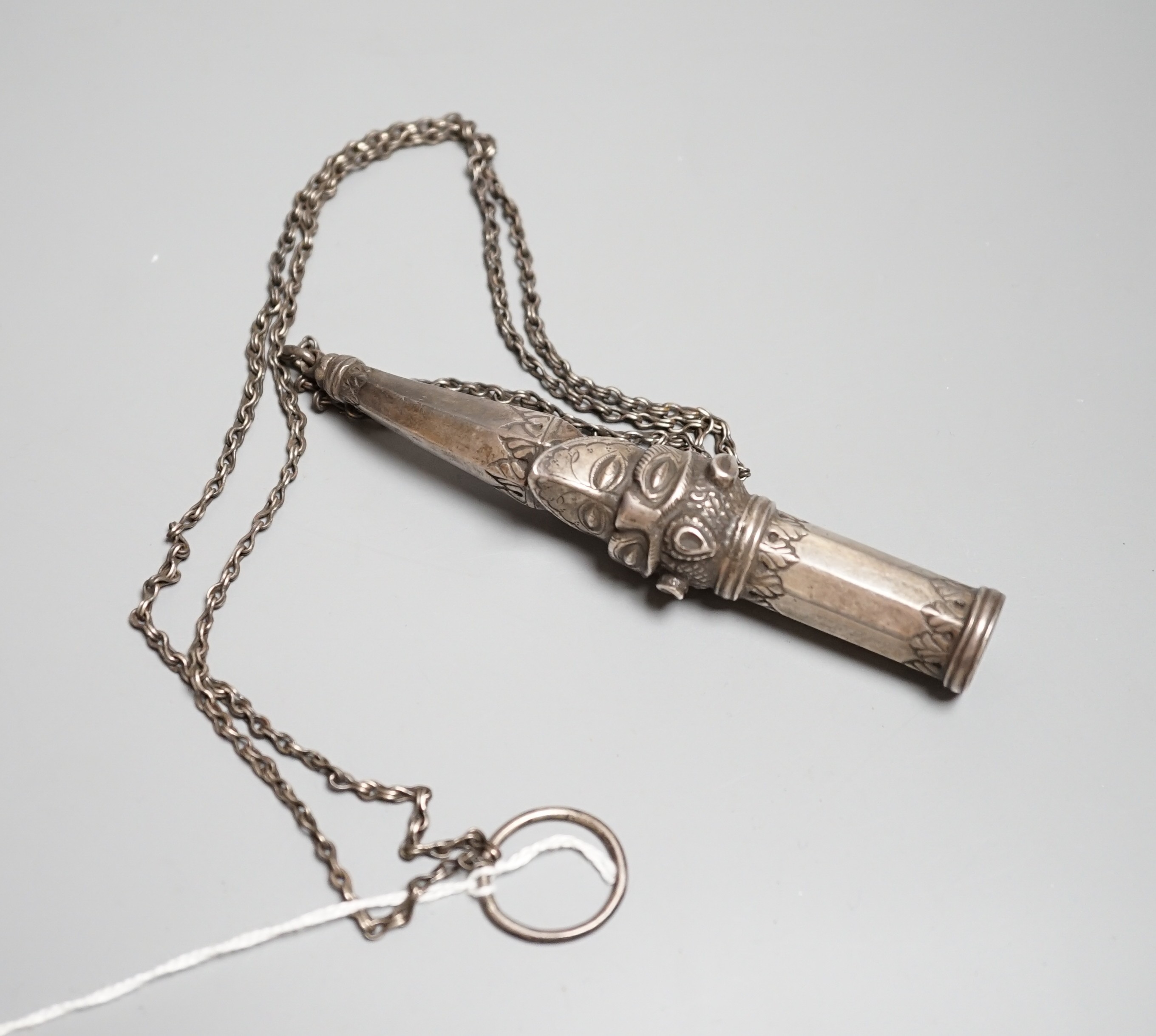 An Indian silver mouthpiece (munal) for the hookah, 19th century, formed with a makarra issuing from a lion’s mouth, silver stopper and chains, length 12.5cms